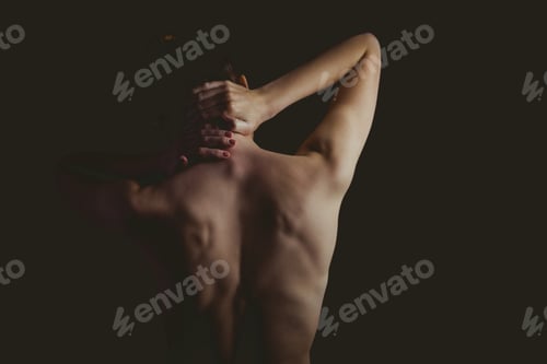 Preview: Nude woman with a neck injury on black background