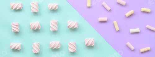 Preview: Colorful marshmallow laid out on violet and blue paper background