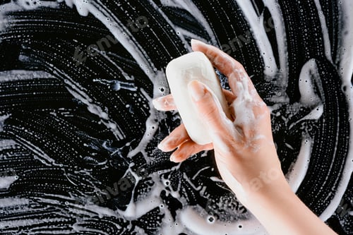 Preview: cropped view of woman holding soap with white foam