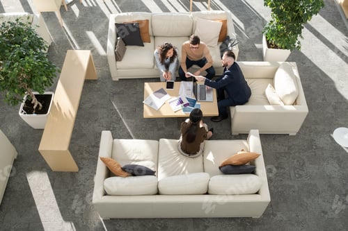 Preview: Group of young analysts discussing documents with data