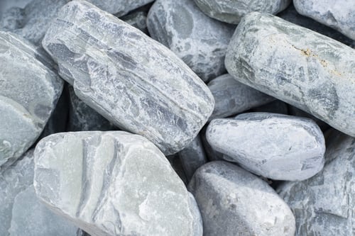 Preview: Large blue-gray cobblestone for surface decoration, close-up. Natural stone texture background, top