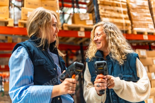 Preview: Coworkers using barcode scan readers in a distribution warehouse