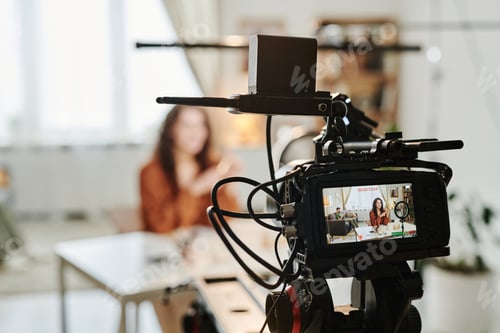 Preview: Woman Recording Herself on a Professional Camera