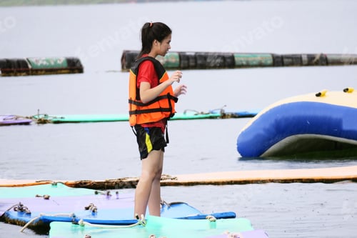Preview: Teenager girl enjoy playing in the water park in the lake in summer holiday closeup background