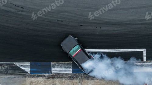 Preview: Aerial top view high speed car drifting on asphalt race track with lots of smoke.