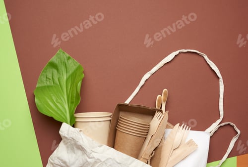 Preview: Disposable paper utensils from brown craft paper and recycled materials on a brown background