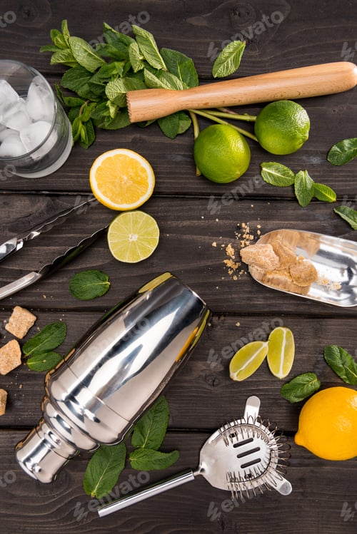 Preview: Top view of mojito cocktail ingredients and utensils on wooden table top, cocktail drinks concept