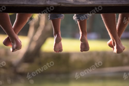 Preview: people sitting at wooden bridge