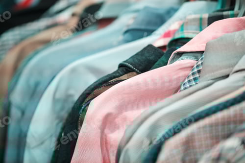 Preview: Neatly Displayed Collared Shirts Hanging in a Closet