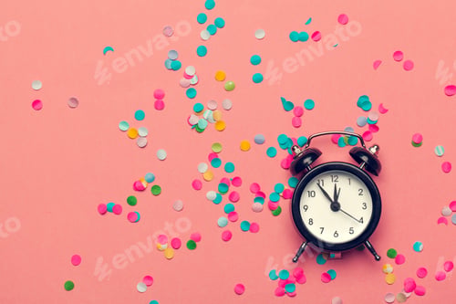 Preview: Clock and party decorations. Macro photo. Close up.