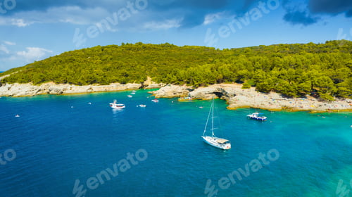 Preview: Aerial view on sail yacht, rocks and forest. Sea coastline. Vacation and adventure.