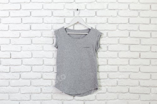Preview: Grey T-Shirt Hanging on White Brick Wall