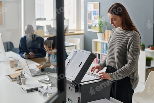 Preview: Woman Making Copy Of Document At Work