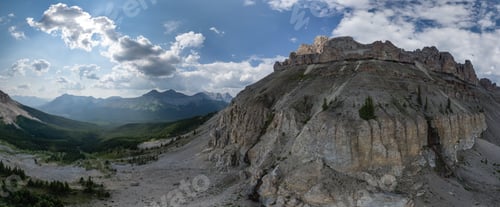 Preview: Majestic Mountain Landscape in Alberta, Canada with Rocky Peaks and Vast Valleys Under a Blue Sky
