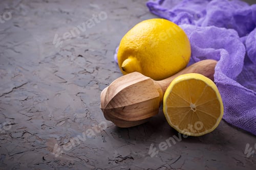 Preview: Fresh lemon and juicer on concrete background