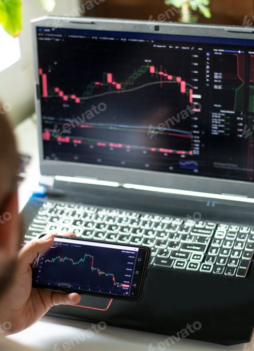 Preview: Close-up of hand holding mobile phone with financial graph monitoring stock
