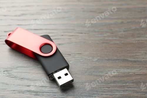 Preview: One flash drive on wooden background, closeup. Space for text
