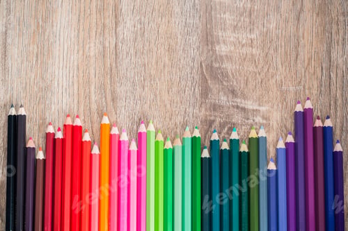 Preview: Multi Color pencils in scale with rainbow style isolated on wooden background