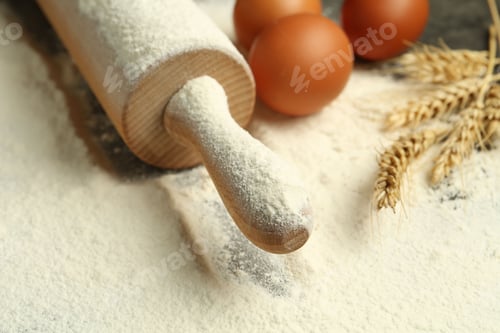 Preview: Wooden rolling pin, eggs, flour and spikes on table, closeup