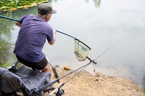 Preview: Successful bream fishing, Happy fisherman with big walleye fish trophy at lake