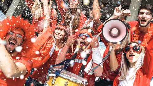 Preview: Friends football supporter fans cheering with confetti watching soccer match