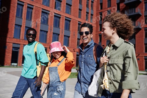 Preview: Young people walking together outdoors on modern college campus