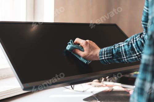 Preview: a hand holding a rag and wipe a digital monitor screen of device