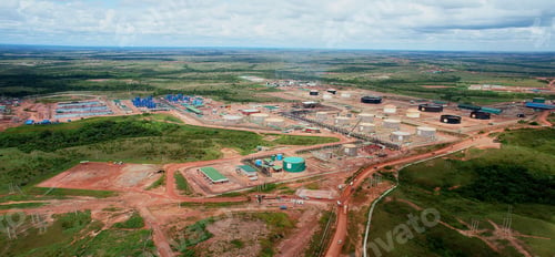 Preview: Panoramic aerial shot of modern complex factories in an industrial area in the daylight.