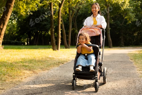 Preview: Japanese Mom Walking With Toddler Daughter In Stroller At Park
