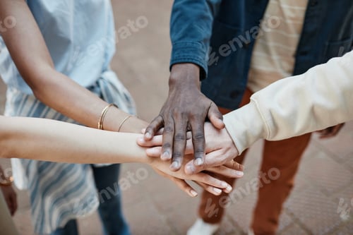 Preview: Group of Friends Stacking Hands Closeup