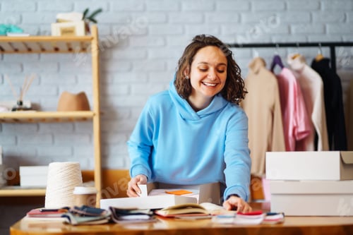 Preview: Close-up of preparing a parcel on the table. Woman online store, small business owner, entrepreneur.