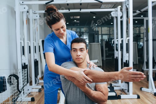 Preview: Man Receiving Physical Therapy From Healthcare Professional