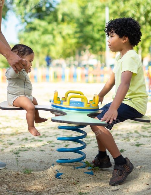 Preview: Two Latino brothers, a boy and a baby in a playground