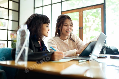 Preview: Friends Studying Together at a Cafe Working on Academic Projects
