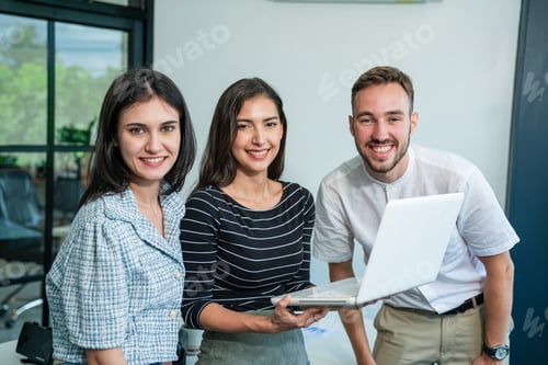 Preview: Happy diverse friends watching funny video together at meeting room.