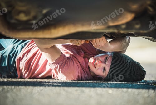 Preview: A woman changes the oil in her truck