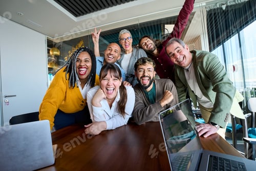Preview: Diverse group of coworkers laughing together during a cheerful office meeting
