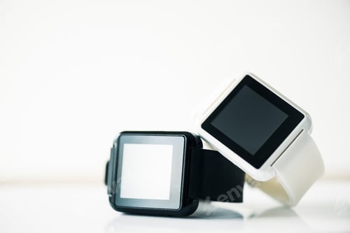Preview: close-up view of smartwatches with blank screens on grey