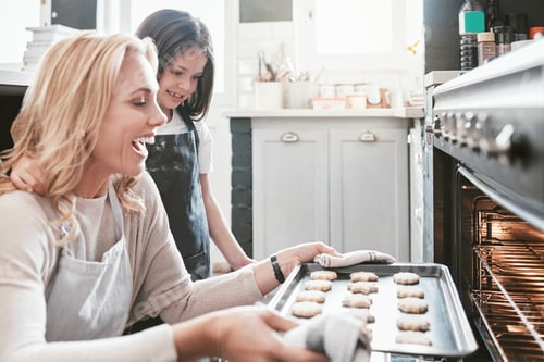 Preview: Kitchen, mom and kid baking cookies in oven, excited with results working together and learning to b