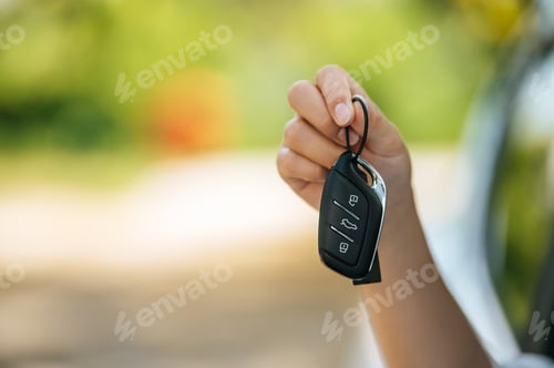 Preview: girl sitting in the car and holding the car keys