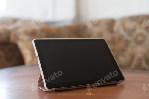 Preview: Digital tablet computer on old wooden desk.