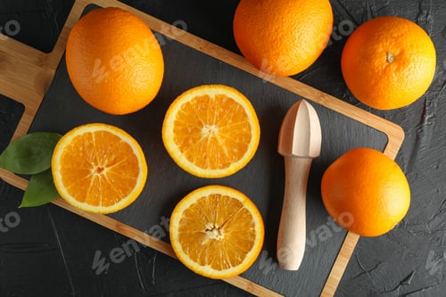 Preview: Composition with cutting board, oranges and wooden juicer. Top view