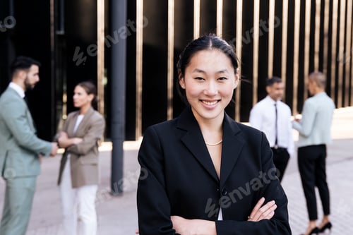 Preview: Portrait of a handsome successful executive woman smiling with her arms crossed. Attractive young