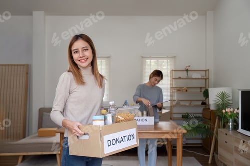 Preview: Woman with charity box and group of volunteers at assistance center. Charity, donation, and