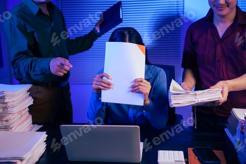 Preview: Two men bring a large workload to a woman at her desk in the office. She feels stressed pressured