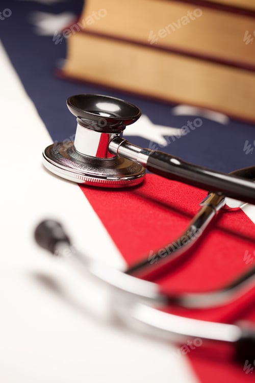 Preview: Stethoscope and Books on American Flag with Selective Focus.