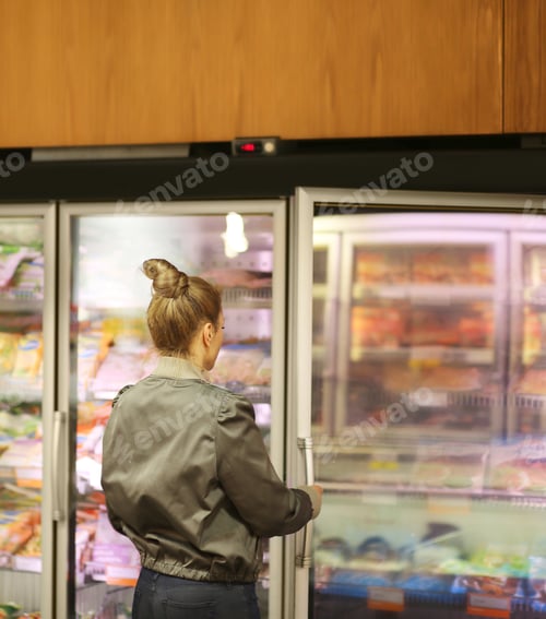 Preview: Woman Choosing Frozen Food From A Supermarket Freezer