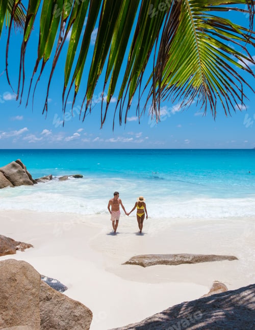 Preview: Anse Lazio Praslin Seychelles, a young couple of men and women on a tropical beach during vacation