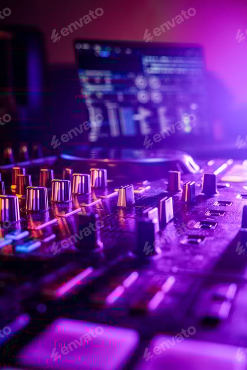 Preview: Professional audio mixing board connected to a laptop, displaying the various knobs and buttons.