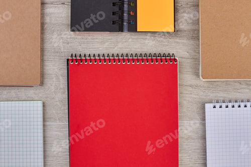 Preview: Group of paper notebooks on wooden background.